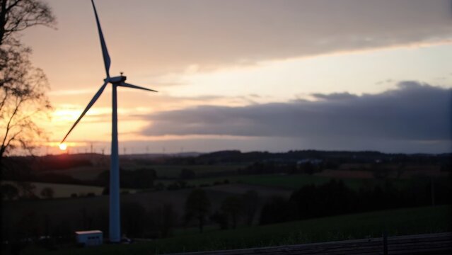 Blurred wind turbine silhouette with real-time energy analytics dashboard overlay
