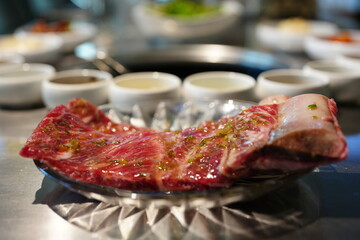 Korean BBQ with Raw Beef Short Ribs Grilled on Charcoal at Local Galbi Restaurant
