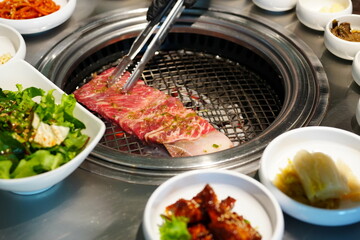 Korean BBQ with Raw Beef Short Ribs Grilled on Charcoal at Local Galbi Restaurant