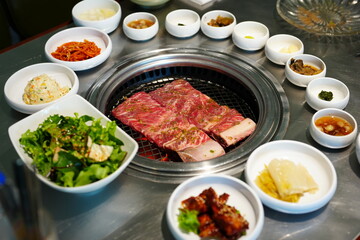 Korean BBQ with Raw Beef Short Ribs Grilled on Charcoal at Local Galbi Restaurant