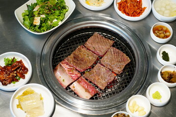 Korean BBQ with Raw Beef Short Ribs Grilled on Charcoal at Local Galbi Restaurant