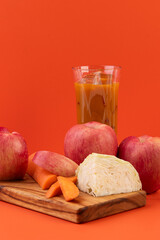Fresh Apple, Carrot, and Cabbage Juice with Ingredients on Cutting Board