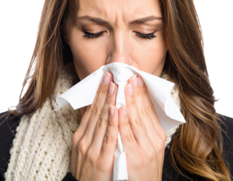 Sick woman blowing nose with tissue showing cold, flu, allergies and illness symptoms