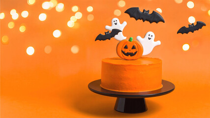 ハロウィン　オレンジ色のかぼちゃのケーキと飛んでるハロウィンクッキー