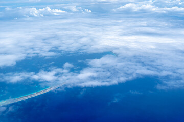 Aerial view of the Tuamotus atoll in French Polynesia with clouds