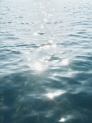 Blue morning light reflecting on calm ocean at dawn.

