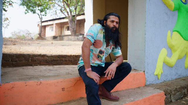 Rowdy Villager Chews Tobacco on Colorful Steps