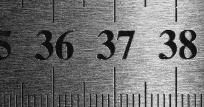 Metal Ruler Close-Up. Video featuring a detailed view of a sleek metal ruler with precise millimeter markings, captured in high clarity.