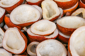 Organic dried coconut pieces, split open to reveal their pure white flesh and rustic brown shells, offering a wholesome, natural, and tropical food source.