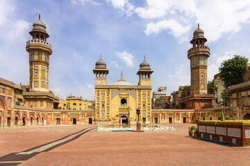 Masjid Wazir Khan, a stunning 17th-century mosque in Lahore, Pakistan, features intricate tile...