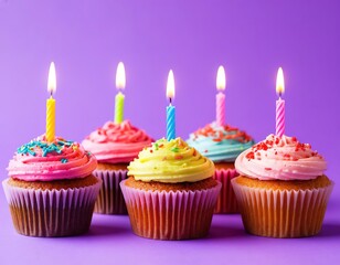 cupcakes with candles on lavender background.