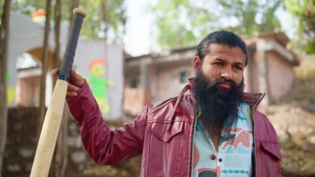 Bearded felon holds pistol while swinging stick in rage
