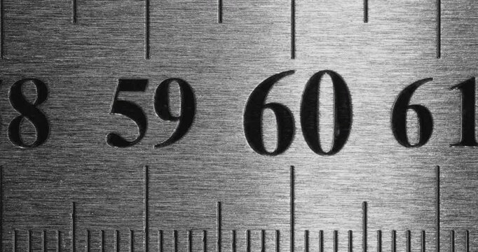 Metal Ruler Close-Up. Video featuring a detailed view of a sleek metal ruler with precise millimeter markings, captured in high clarity.