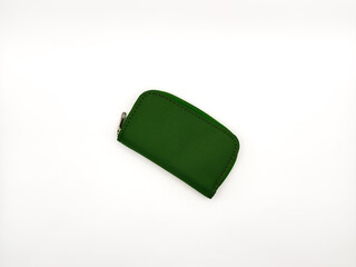 Small green fabric wallet with zipper on white background. copy space, flay lay, top view. High quality photo