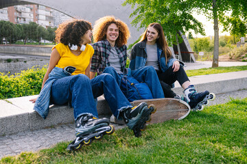 Three young skater friends laughing and enjoying carefree moments together in a vibrant park,...
