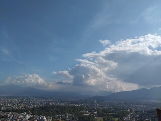 Panoramic View of Kathmandu Valley with Dramatic Clouds and Blue Sky over the Himalayan Foothills, Nepal