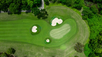 Aerial top view golf course with lush greens, green fairway and sand bunker, Golf course green grass and trees fairway and putting green, Beautiful golf course.