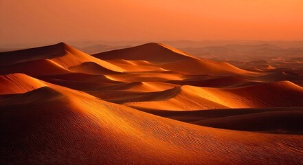 Golden hour sunset casts dramatic shadows across vast undulating sand dunes creating a breathtaking desert landscape with rippled textures
