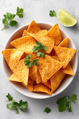 A bowl of tortilla chips with a bunch of cilantro on top