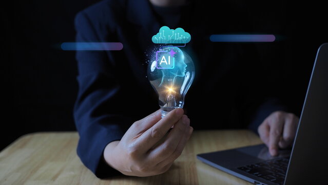 businesswoman’s hand holding a glowing light bulb, symbolizing artificial intelligence, creative innovation, and future-thinking in business and technology.