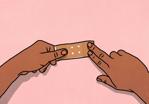 Point of view from above of hands flattening bandage over pink background
