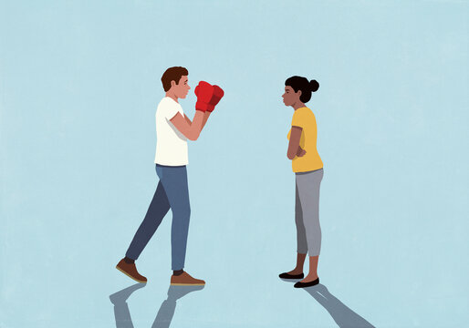 Man in boxing gloves standing in fighting stance face to face with wife on blue background
