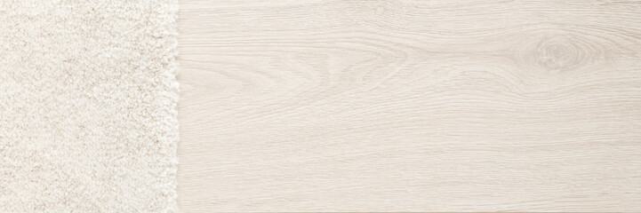 White new fluffy home carpet on light color laminate background. Wide banner. Closeup. Empty place for text. Top down view.