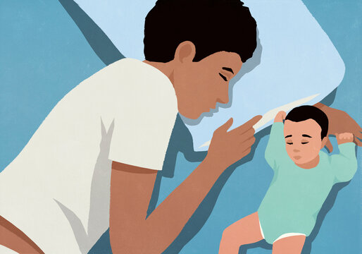 View from above of tired father sleeping next to newborn son in bed
