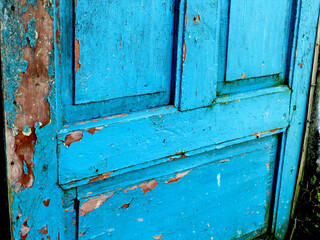 The old blue door is an antique from the past.