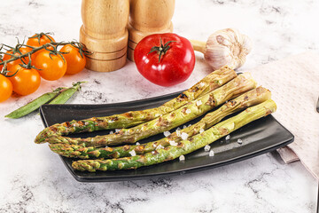 Grilled asparagus sprouts served red pepper