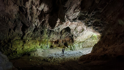 The enormous entrance hall of Szeleta Cave in the Bükk Mountains, Hungary, with a person for scale to show the cavern’s impressive size.