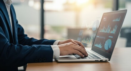 Business professional analyzing financial data and market trends on a laptop with holographic charts