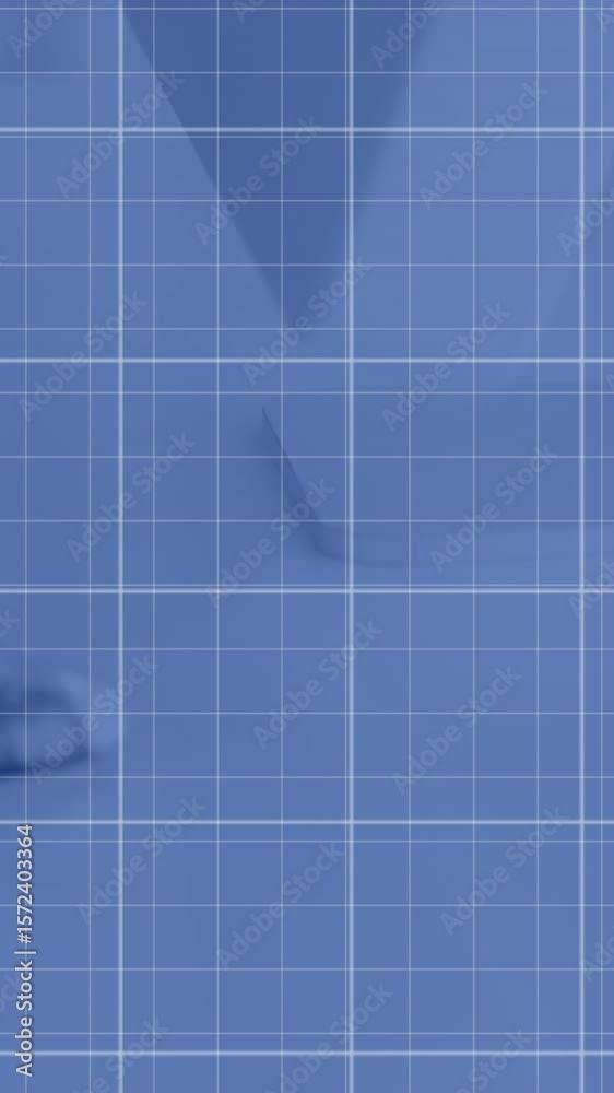 Poster animation of graphs over grid pattern against keyboard and computer on desk in office