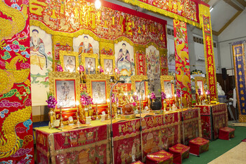 Vibrant altar adorned with intricate decorations, featuring colorful tapestries, statues, and offerings. atmosphere is rich with cultural significance and spiritual reverence