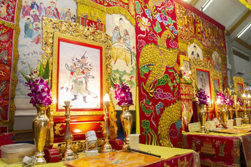 Vibrant display of traditional decorations featuring intricate gold details and colorful artwork, showcasing cultural heritage and spirituality. arrangement includes floral arrangements and ornate