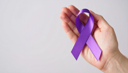 Hand holding purple awareness ribbon. Pancreatic cancer, Alzheimer disease, epilepsy