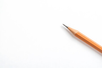 Writing implement: A pencil lays on a white surface ready for writing or drawing projects. Sharp, versatile tool for creative work.