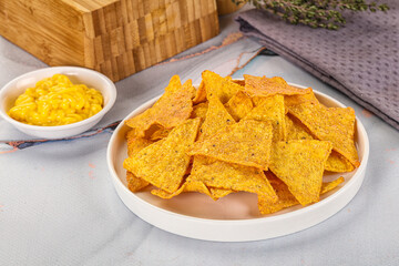 Corn nachos chips with cheese dip
