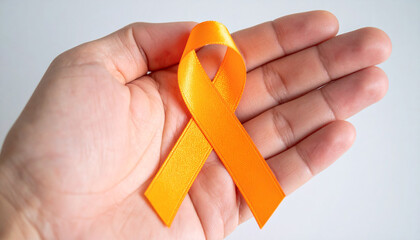 Hand holding orange awareness ribbon. Leukemia, multiple sclerosis, gun violence prevention