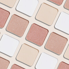 Swatches eyeshadow refills as minimal monochrome pattern. Matte and glitter pans white beige pink...