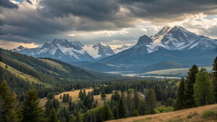 Fototapeta premium Majestic snowcapped mountains rise above a lush green valley under a dramatic sky, creating a breathtaking landscape of natural beauty and serene wilderness