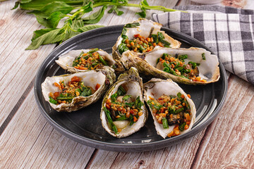 Gournet grilled oysters with onion and peanut