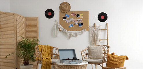 Fototapeta premium Interior of room with mood board, vinyl disks and armchairs