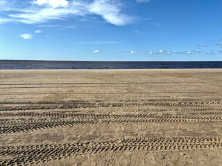 Tire tracks on a deserted beach