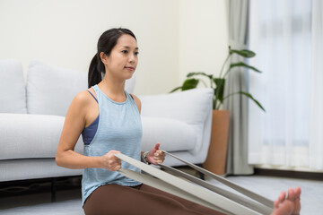 Woman doing morning stretching exercise in cozy home