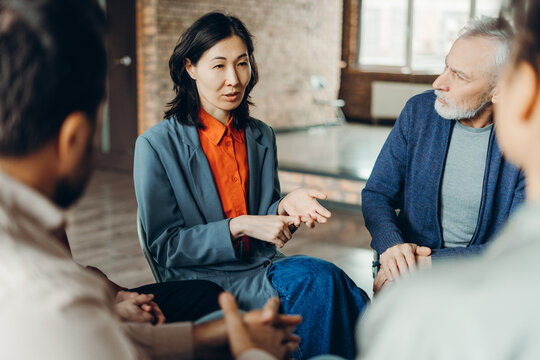Asian businesswoman leading a team meeting in a modern office
