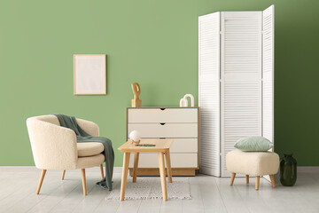 Modern living room interior with white armchair, chest of drawers and folding screen