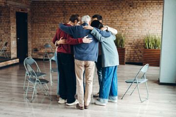 Team members hugging each other during group therapy session