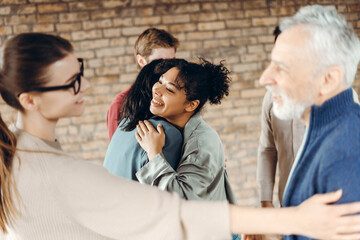 Patients are hugging each other during group therapy session