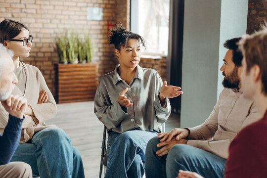 African American woman leading group therapy session for mental health
